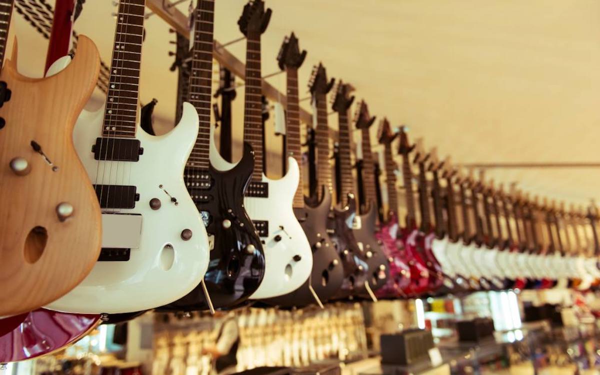 Lineup of guitars hanging on a wall